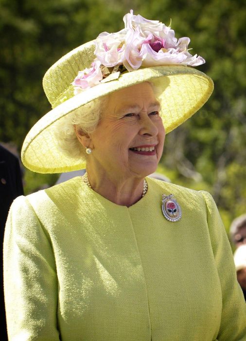 HM The Queen wearing a green hat and coat