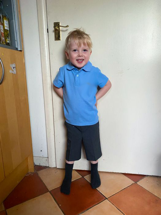 Thomas wearing his school polo shirt and grey shorts