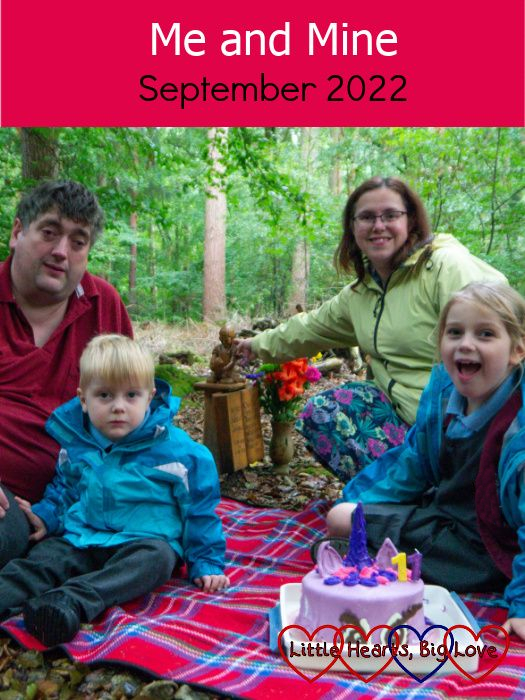 My husband, Thomas, me and Sophie sitting on a picnic blanket at Jessica's forever bed with her Twilight Sparkle unicorn birthday cake on the picnic blanket in front of us - "Me and Mine - September 2022"