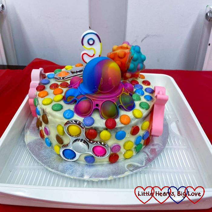Sophie's fidget-toy themed birthday cake decorated with fidget toys and smarties