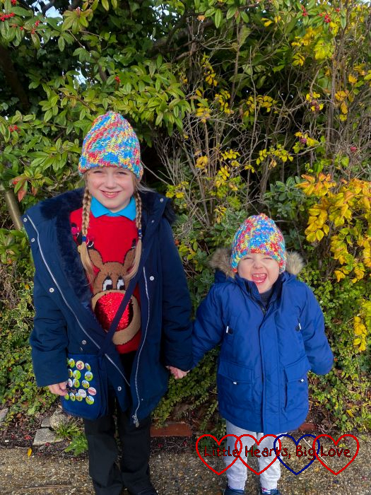 Sophie and Thomas wearing matching rainbow-coloured woollen hats