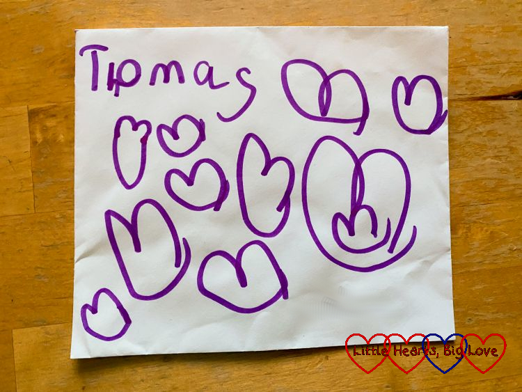 An envelope with 'Thomas' surrounded by lots of hearts