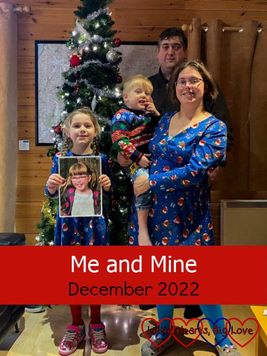 Me (holding Thomas), hubby and Sophie (holding a photo of Jessica) standing in front of a Christmas tree - "Me and Mine- December 2022"