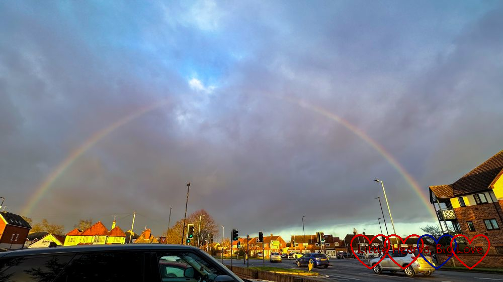 A rainbow above a road intersection