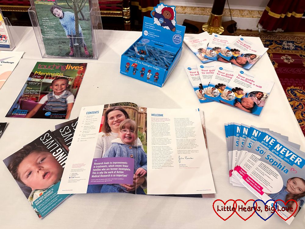 Publications from Action Medical Research on a table with one open showing Jessica's photo on the inside front page