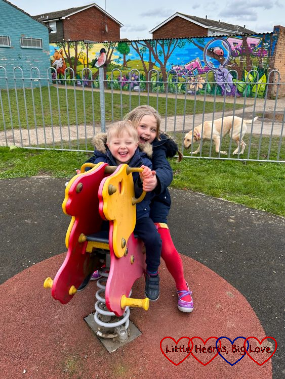 Sophie and Thomas on a rocking lion at the park