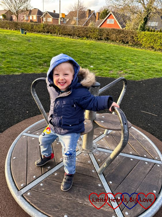Thomas on the roundabout at the park