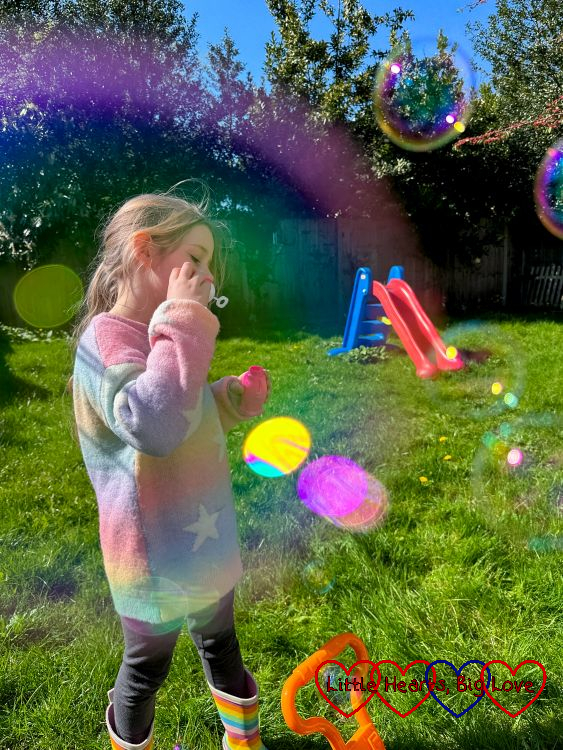 Sophie blowing bubbles in the garden