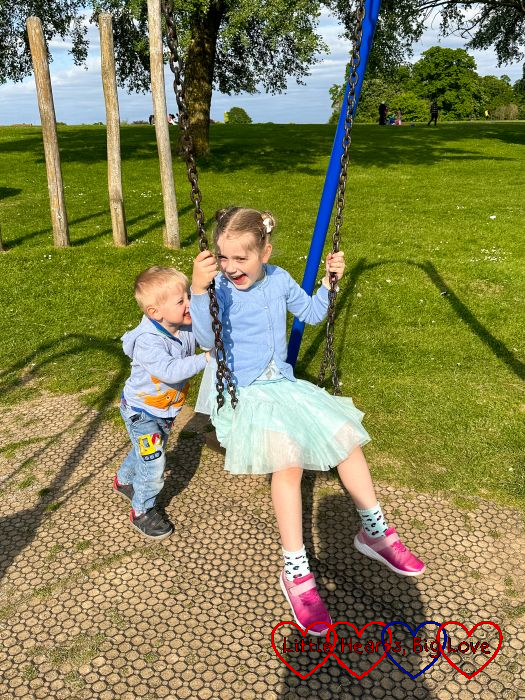 Thomas pushing Sophie on the swing