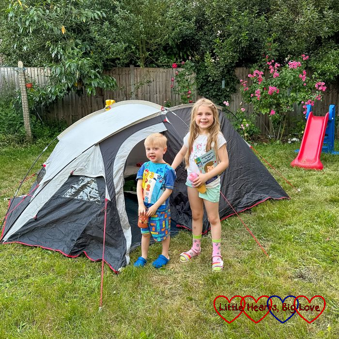 Sophie and Thomas standing in front of a tent in the garden