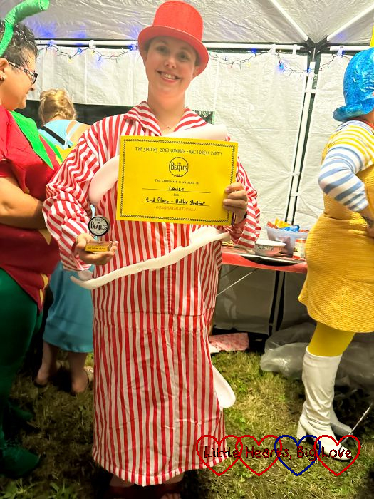 Me in my helter-skelter costume with a trophy and certificate for 2nd place