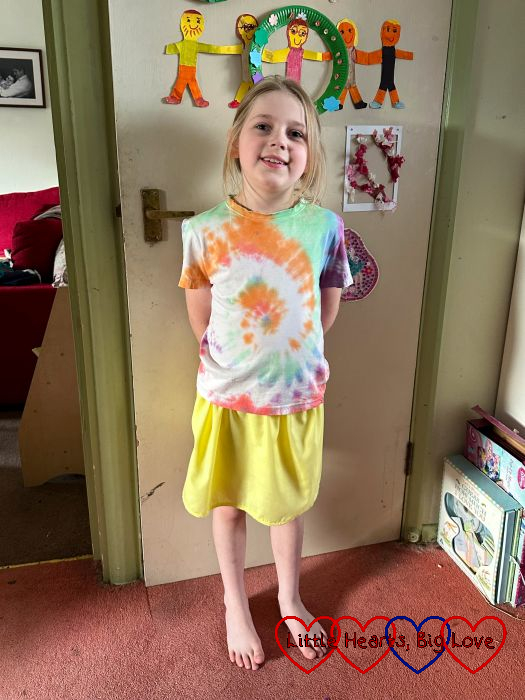 Sophie wearing a tie-dyed T-shirt and a handmade yellow skirt