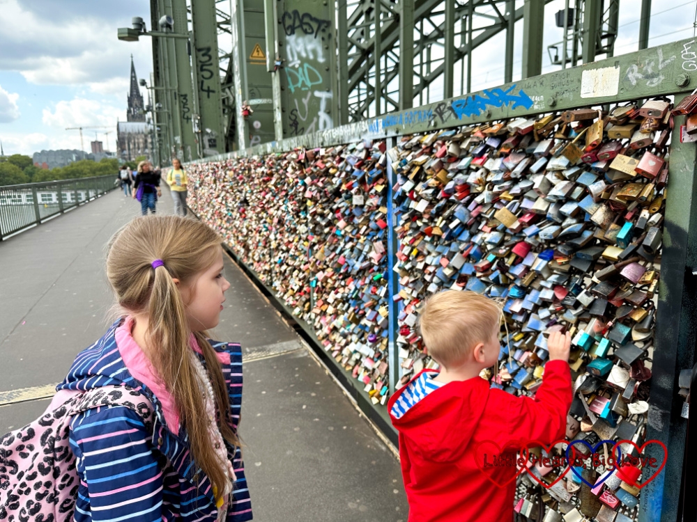 Sophie and Thomas looking at love padlocks on a bridge