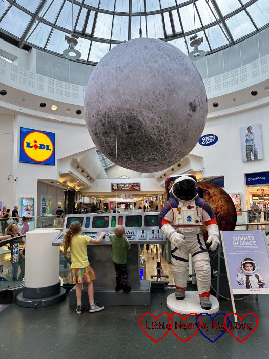 A model of the moon and a space centre console in a shopping centre