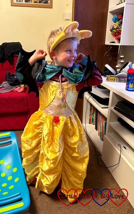 Thomas wearing a yellow princess dress and green cape with Pudsey ears