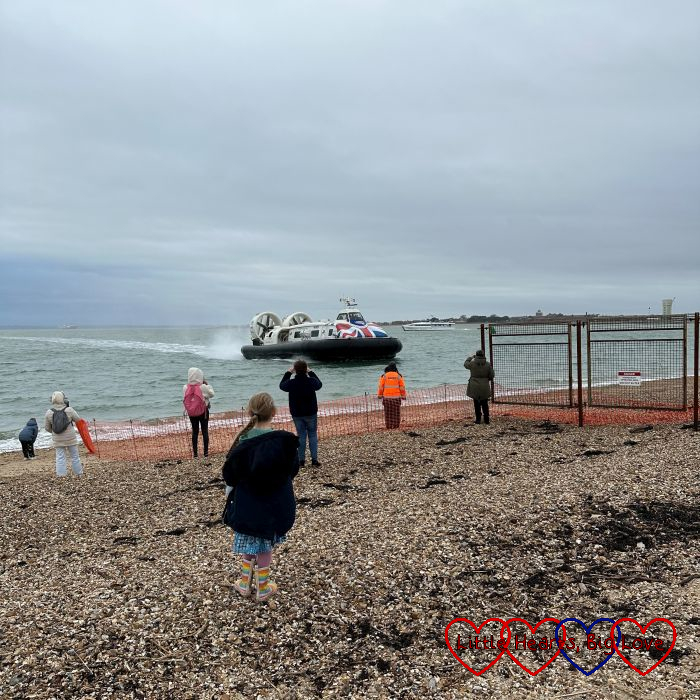 Sophie standing on Southsea beach watching the hovercraft coming in
