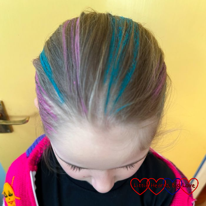 Sophie with pink and blue hair chalk streaks in her hair